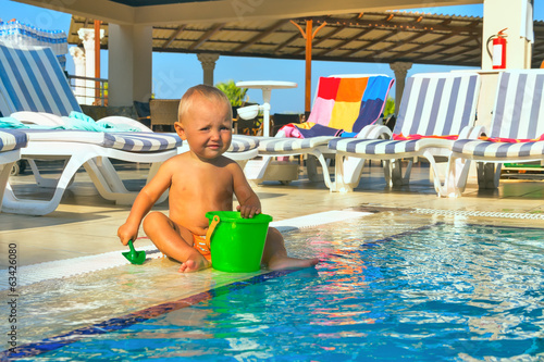 Kid playing pool in hotel