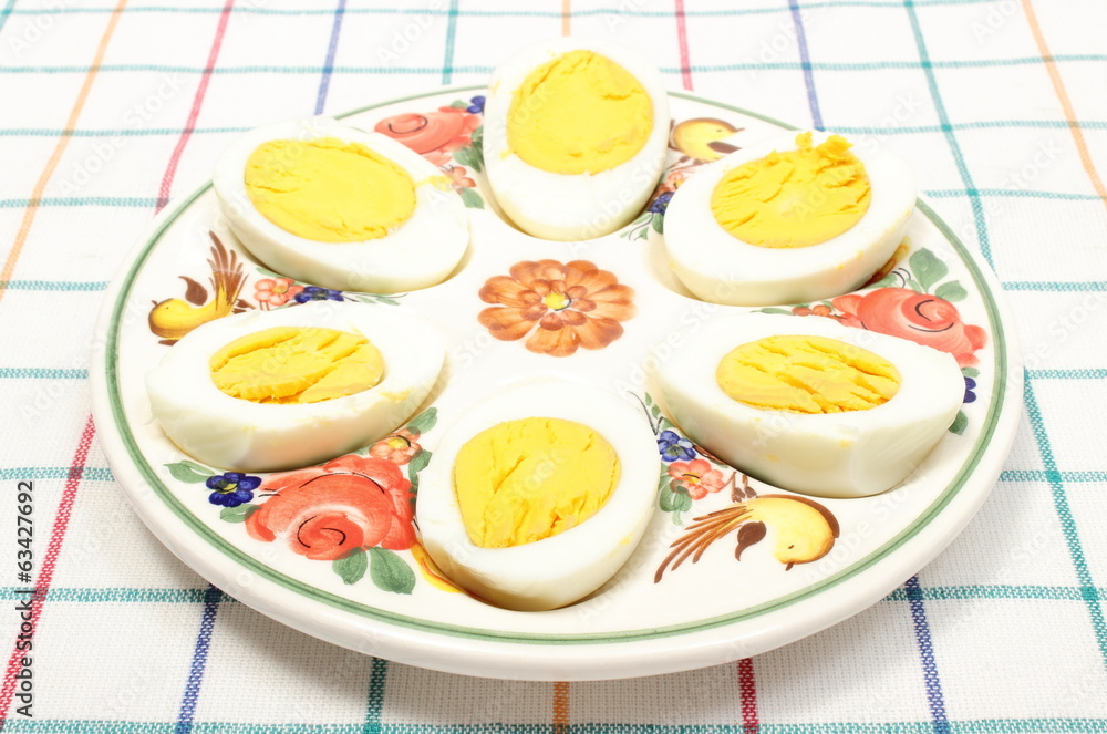 Halves of eggs lying on colorful plate Halves of eggs lying on colorful plate