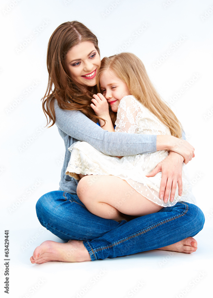 Mother and daughter sitting on a floor. Mother and daughter sitting on a floor.