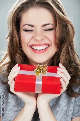 Gift box woman hold against gray background. © Yuriy Shevtsov