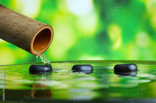 Spa still life with bamboo fountain  on bright background