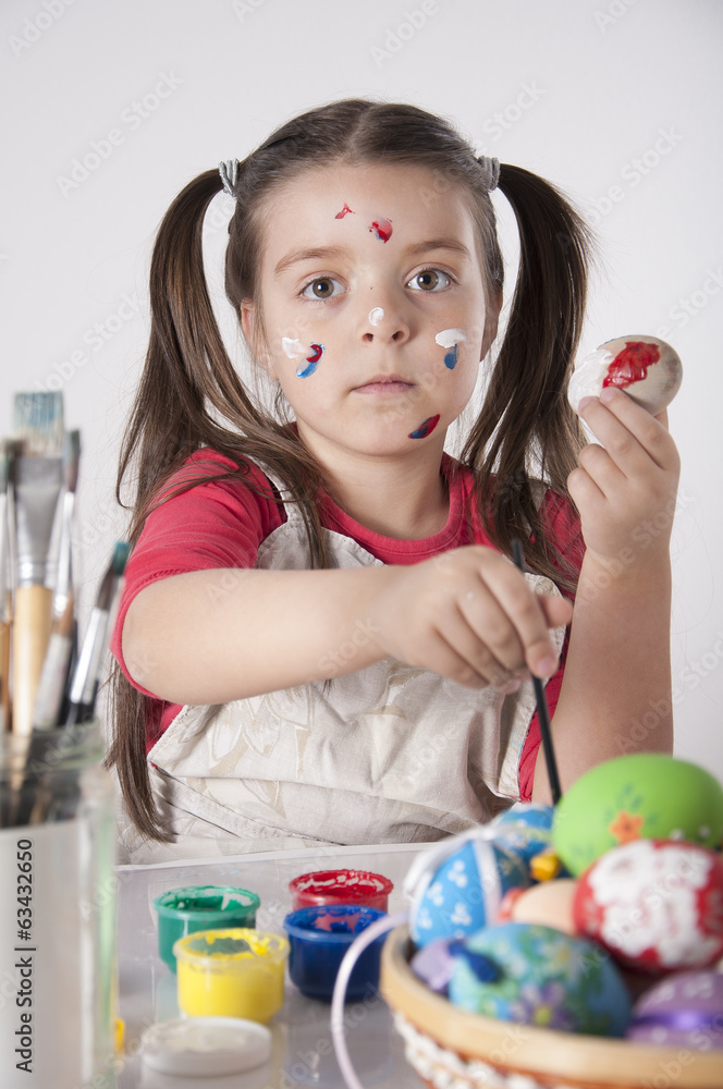 A happy little girl holdin painted easter eggs A happy little girl holdin painted easter eggs