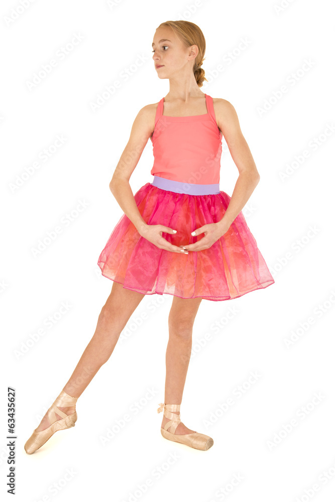 cute young girl ballerina posing wearing a pink tutu