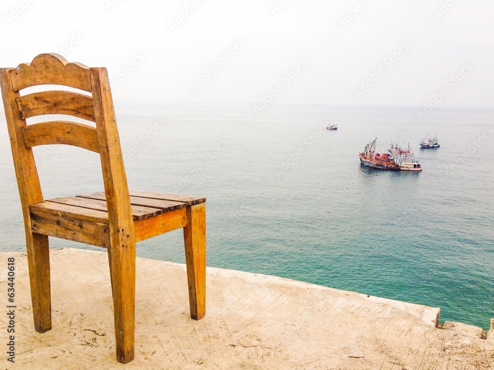 A wooden chair at panorama sea view point