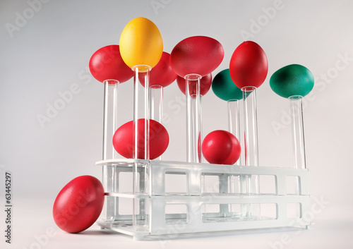 Happy Easter! Colorful Easter eggs placed on test tubes.