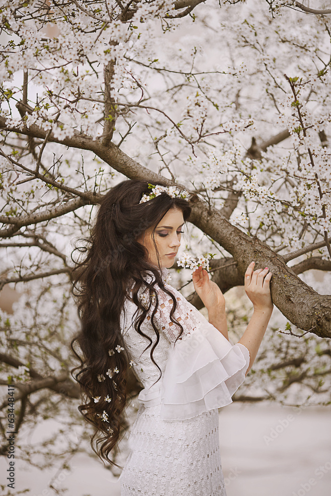 portrait of young lovely woman in spring flowers portrait of young lovely woman in spring flowers