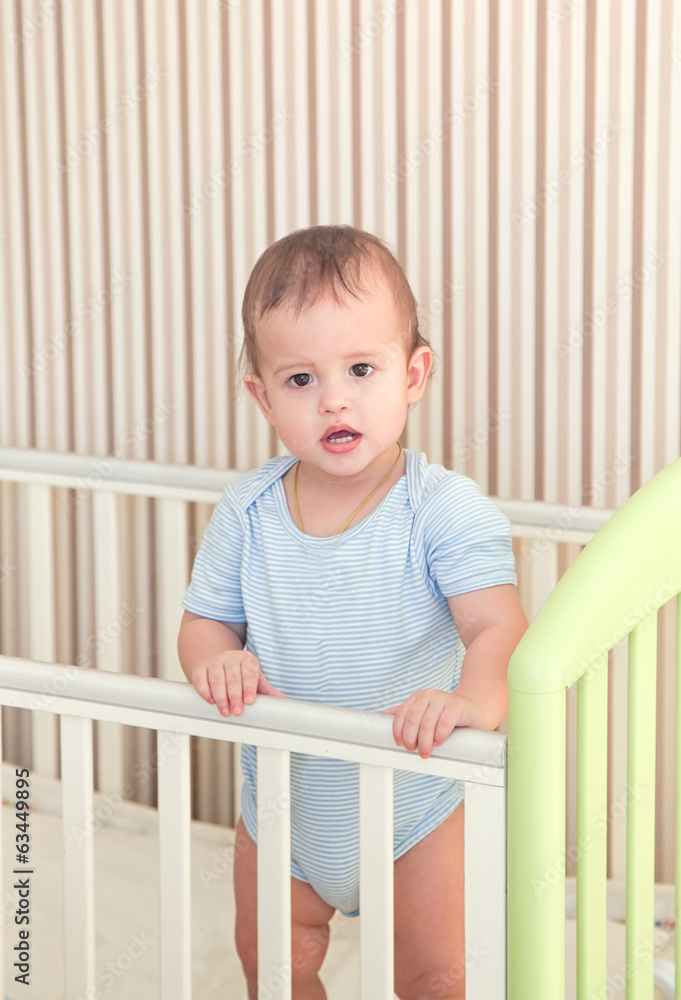 toddler child in a bed after waking up or before. toddler child in a bed after waking up or before.