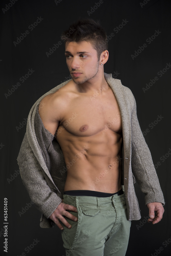 Fototapeta premium Attractive young man with open jacket on muscular torso