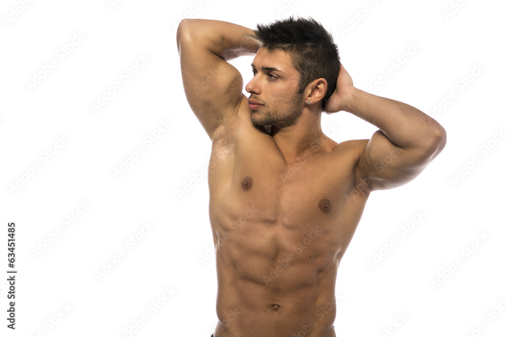 Muscular young bodybuilder showing biceps and ripped abs Muscular young bodybuilder showing biceps and ripped abs