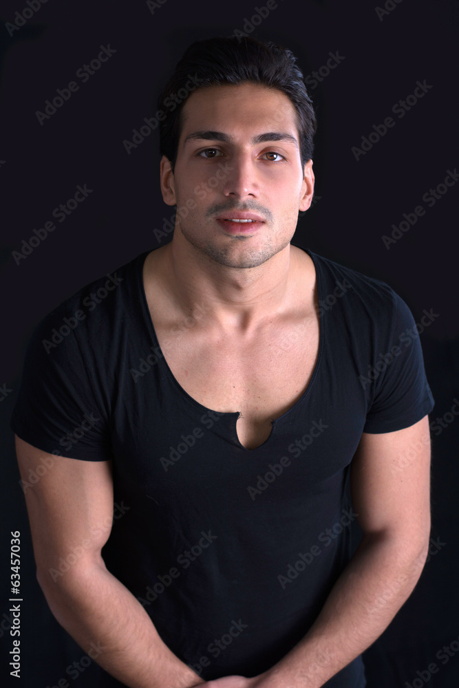 Brown eyed, black haired latin man on dark background Brown eyed, black haired latin man on dark background
