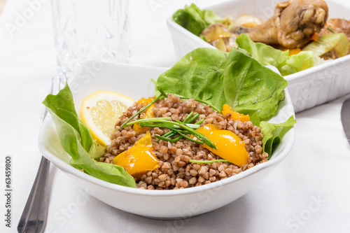 Fototapeta Naklejka Na Ścianę i Meble -  buckwheat with lemon and letuce and fried chicken