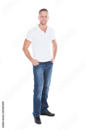 Relaxed sexy attractive young man in jeans and a white t-shirt