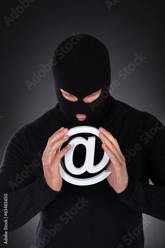 Hacker with an internet domain symbol