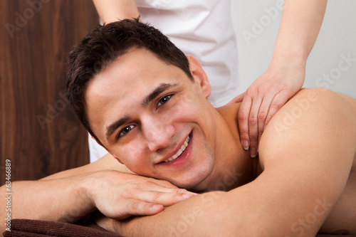 Man Receiving Shoulder Massage In Spa