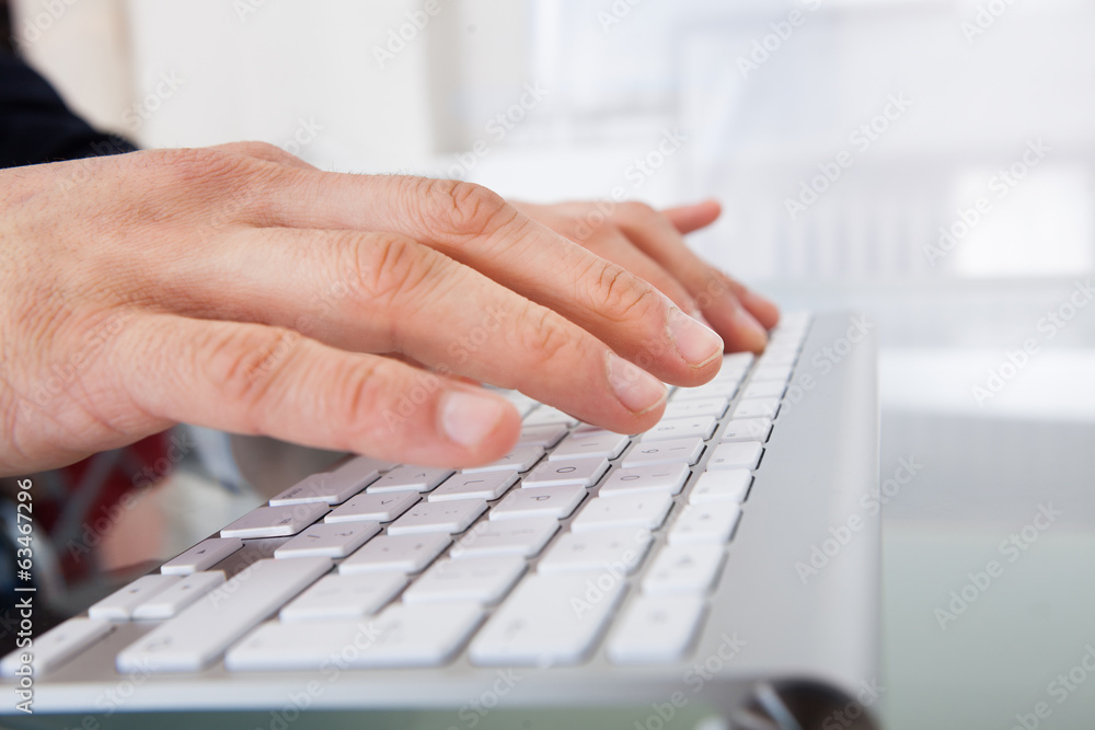 Businessman Typing On Keyboard At Desk Businessman Typing On Keyboard At Desk