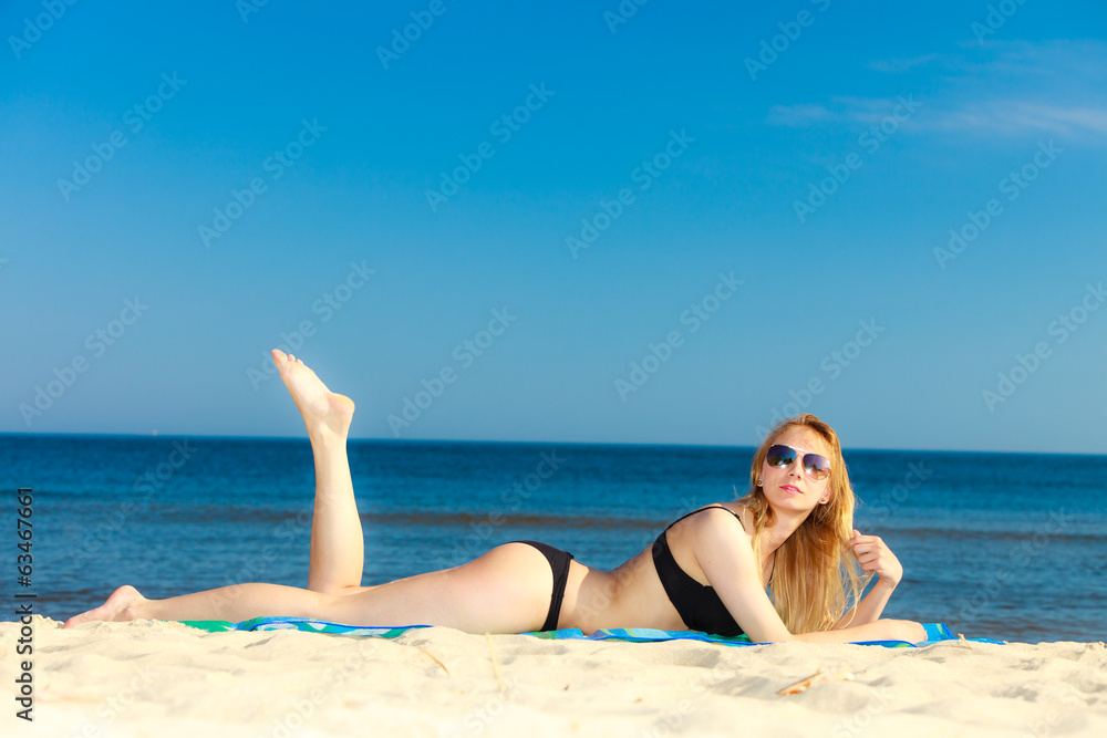 Summer vacation Girl in bikini sunbathing on beach