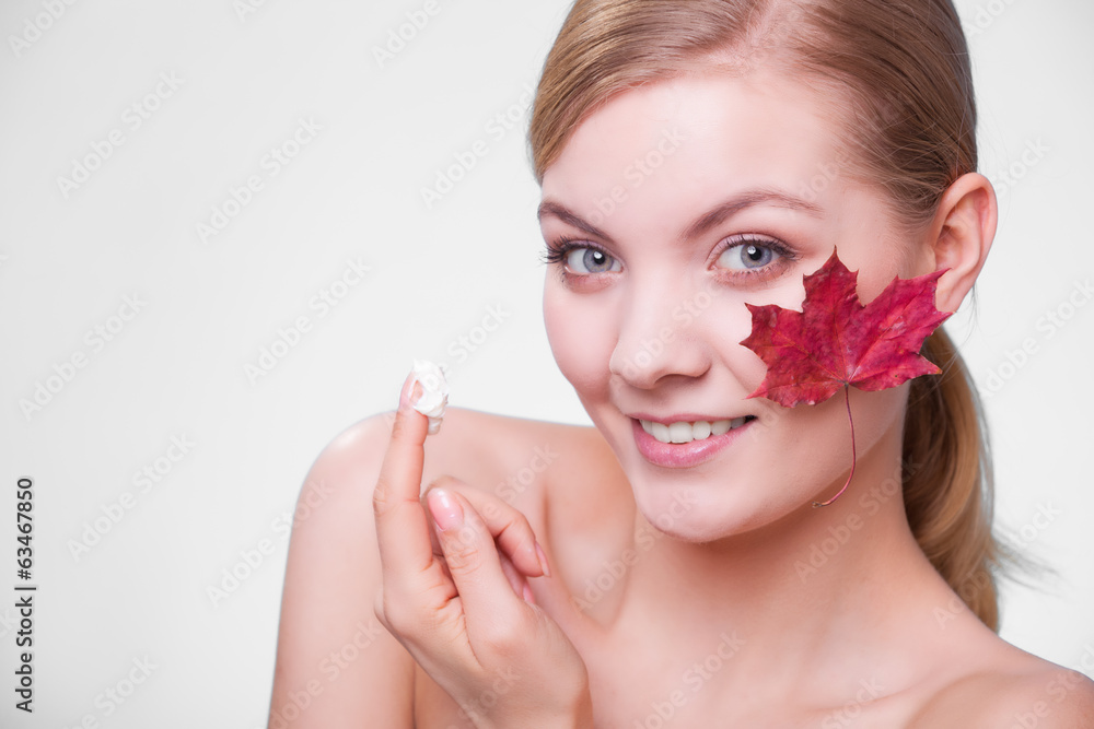 Skin care. Face of young woman girl with red maple leaf. Skin care. Face of young woman girl with red maple leaf.