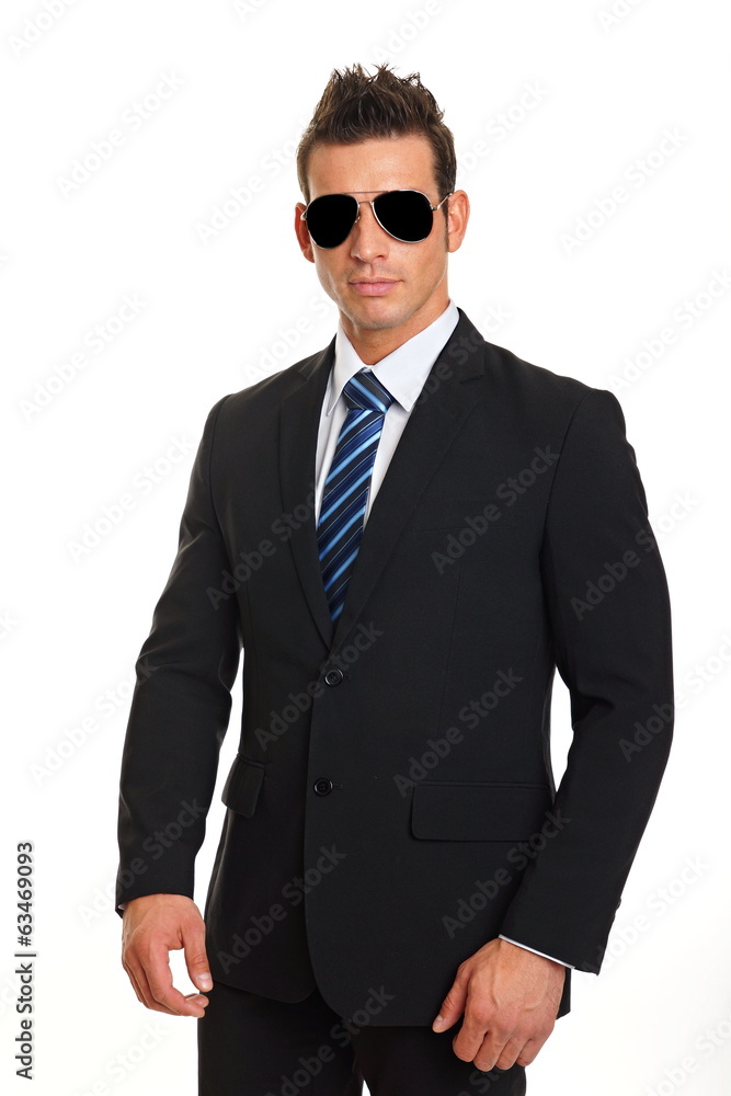 Standing handsome businessman in suit with sunglasses Standing handsome businessman in suit with sunglasses