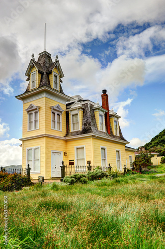 Haunted house by a large grassy field