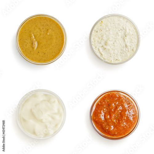 sauces in a gravy boat on white background