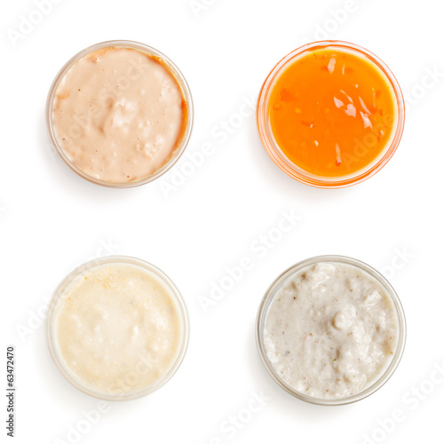 sauces in a gravy boat on white background