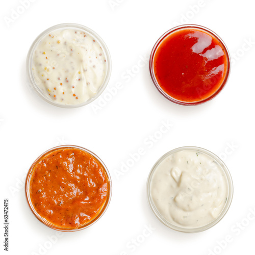 sauces in a gravy boat on white background