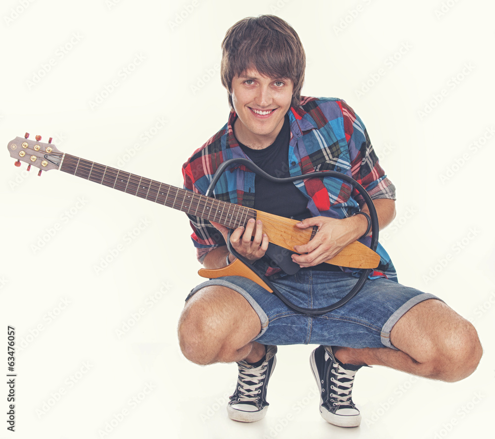 Portrait of young rocker posing in studio on white background Portrait of young rocker posing in studio on white background