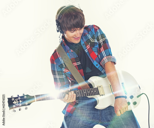 Portrait of young rocker posing in studio on white background
