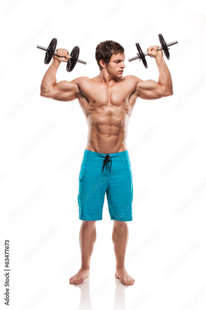 Muscular bodybuilder guy doing exercises with dumbbells over whi Muscular bodybuilder guy doing exercises with dumbbells over whi
