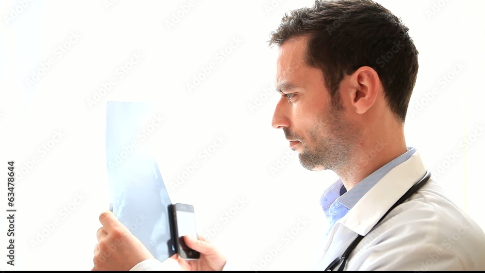 Portrait of a young doctor analysing a radiography Portrait of a young doctor analysing a radiography