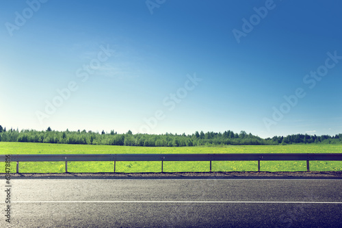 road and field of spring grass