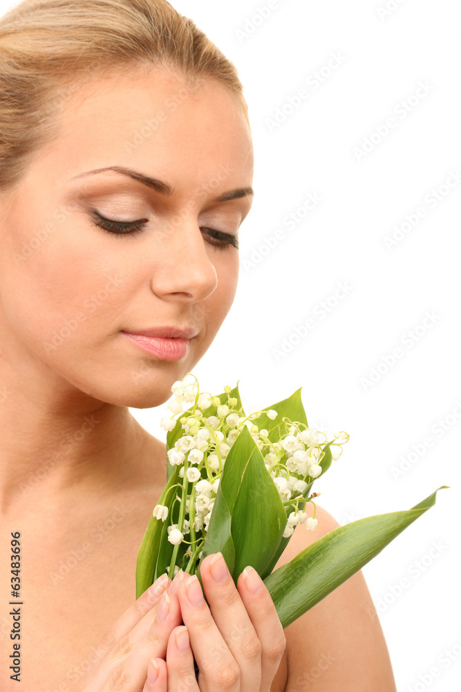 Beautiful young woman with a bouquet of lilies of the valley Beautiful young woman with a bouquet of lilies of the valley
