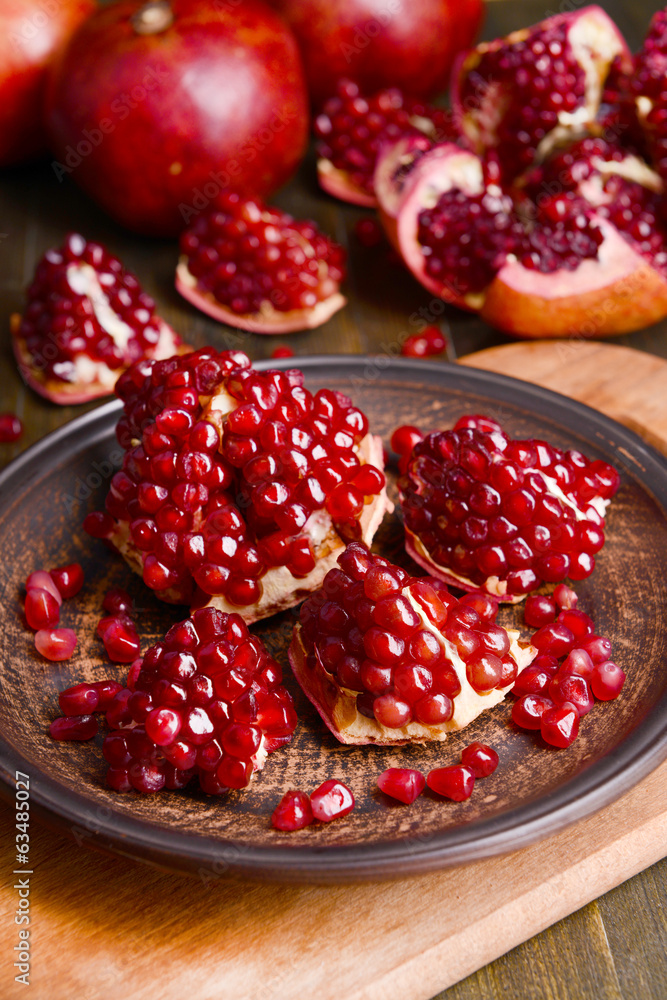 Ripe pomegranates on table close-up Ripe pomegranates on table close-up