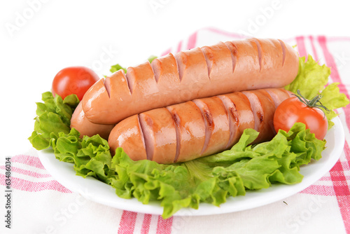 Grilled sausage on plate on table close-up