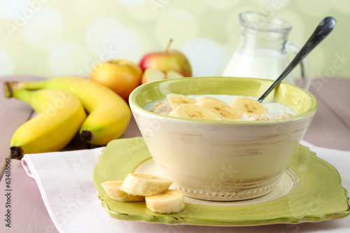 Tasty oatmeal with bananas and milk