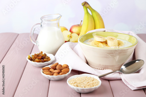 Tasty oatmeal with bananas and milk