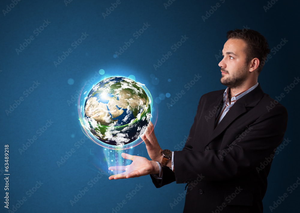 Businessman holding glowing earth globe Businessman holding glowing earth globe