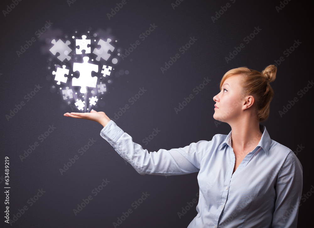 Puzzle pieces in the hand of a businesswoman Puzzle pieces in the hand of a businesswoman