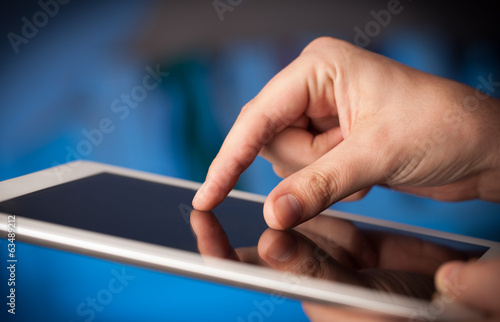 Finger pointing on tablet pc with empty space