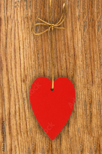 Love heart hanging on wooden texture background, valentines day