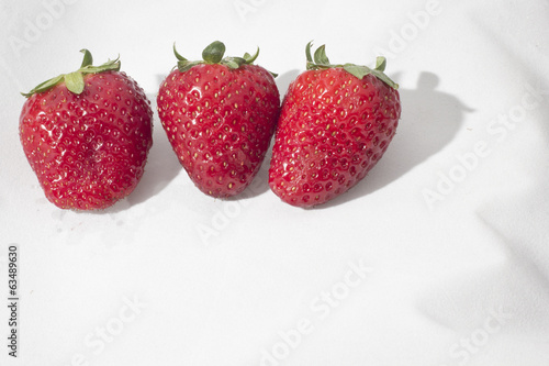 Three strawberries on a white background