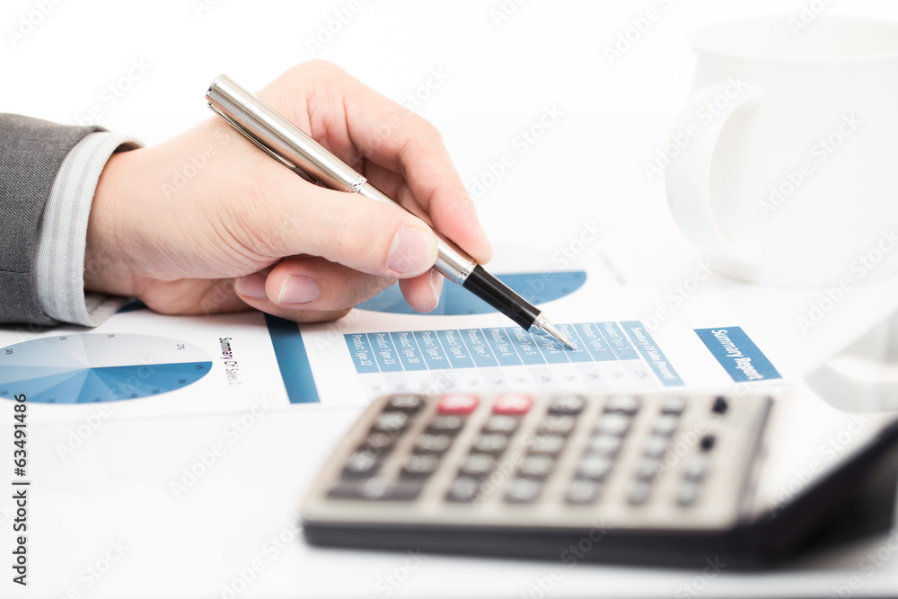 Businessman's hand showing financial report Businessman's hand showing financial report