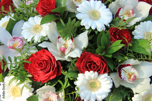 Cymbidium orchids, red roses and white gerberas
