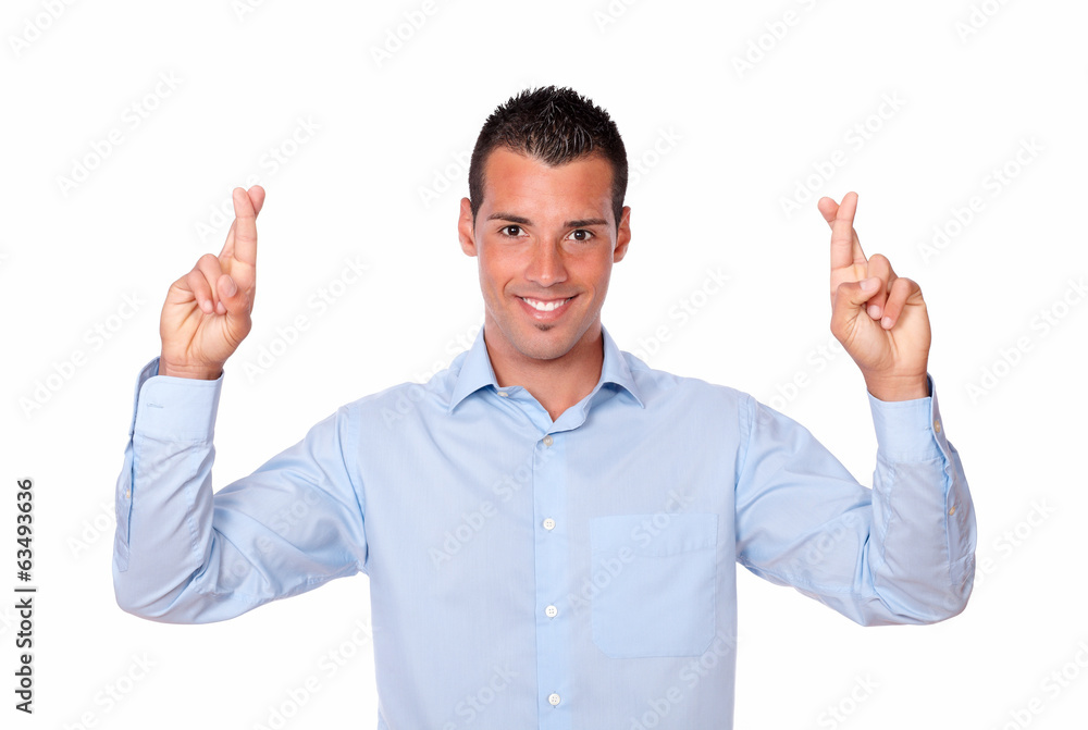 Charming hispanic guy with luck sign Charming hispanic guy with luck sign