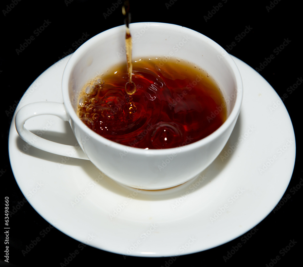 tea in a cup on a black background tea in a cup on a black background