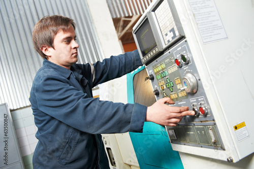 worker operating machine at workshop