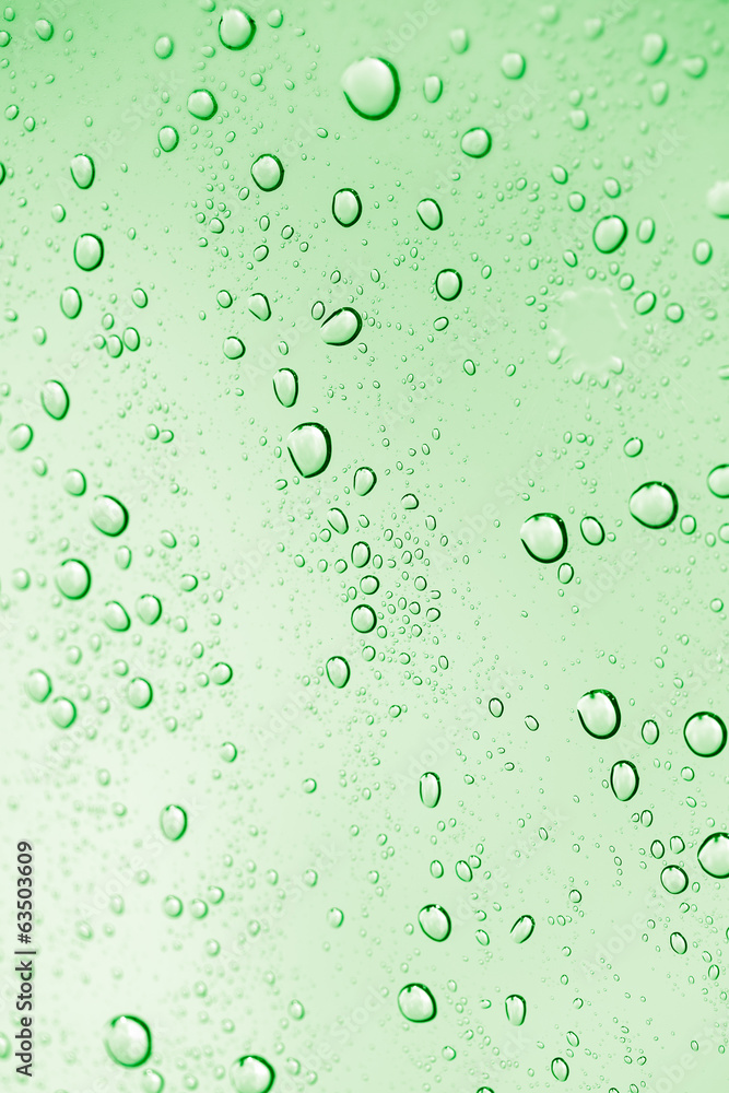 water drops on green glass. macro water drops on green glass. macro