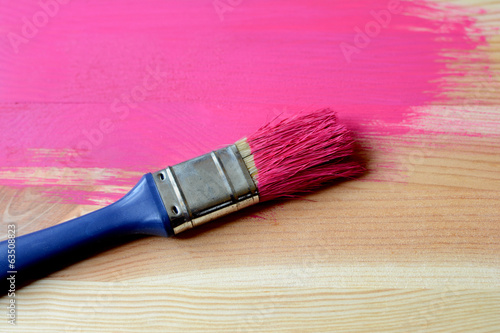 Half-painted wood with paintbrush
