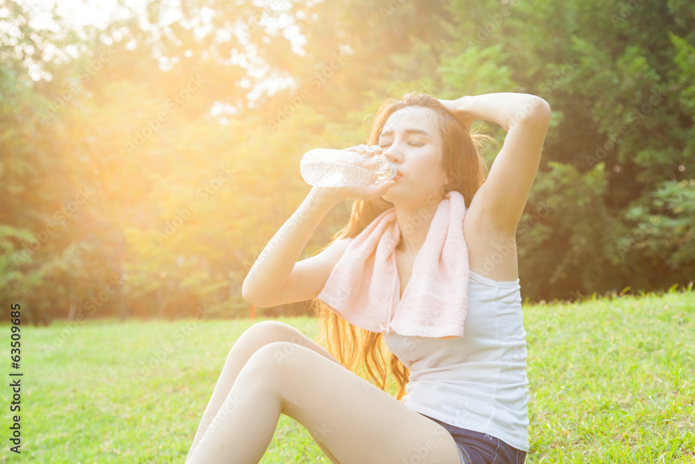 asian woman are drinking and sitting on the lawn. asian woman are drinking and sitting on the lawn.