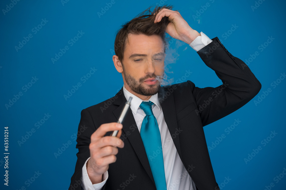 businessman with e-cigarette wearing suit and tie on blue businessman with e-cigarette wearing suit and tie on blue
